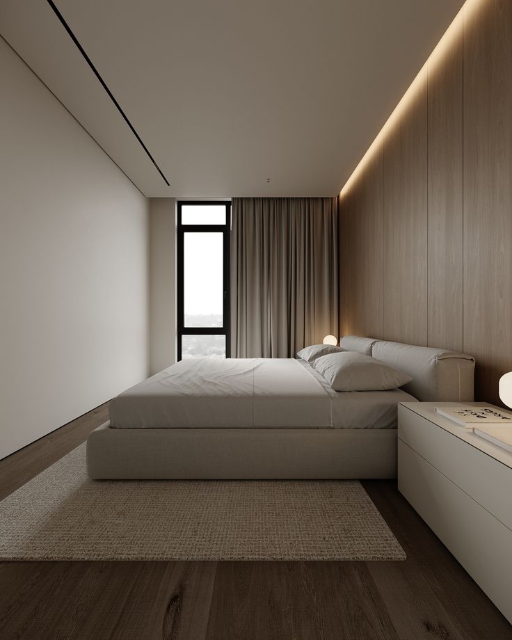 a large white bed sitting next to a window in a room with wooden flooring