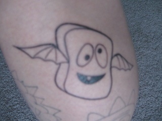 a close up of a person's leg with a cartoon character on it