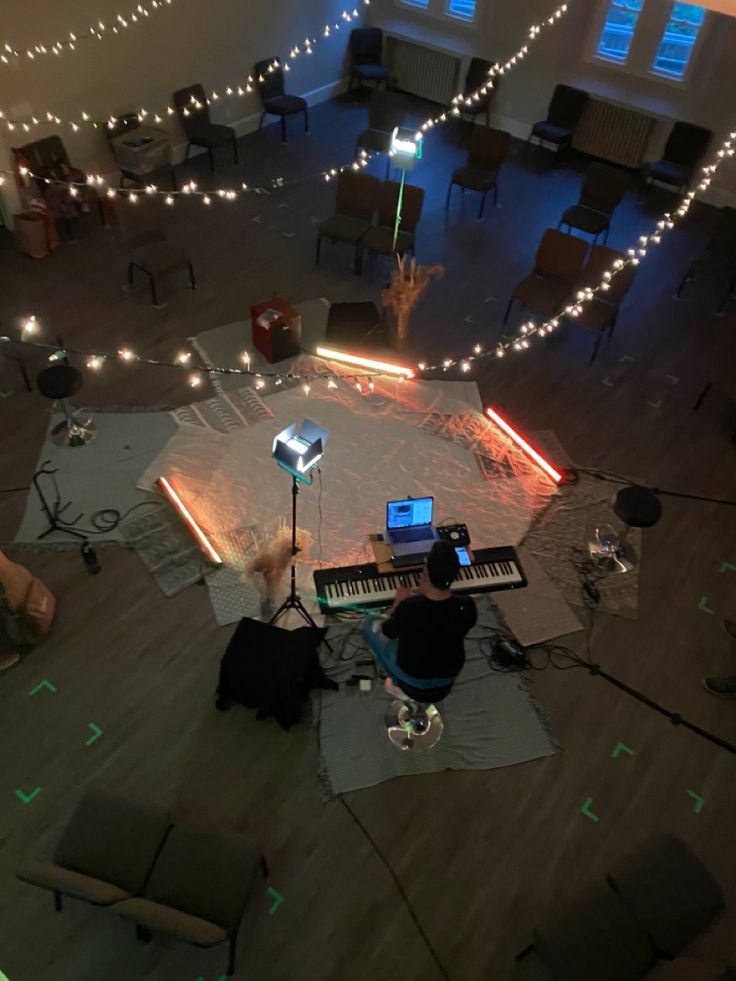 an overhead view of a living room with lights on the floor and piano in the middle