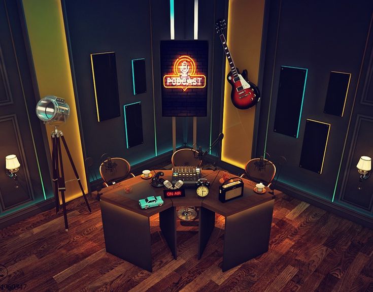 a room with two chairs, a table and a guitar on the wall in it