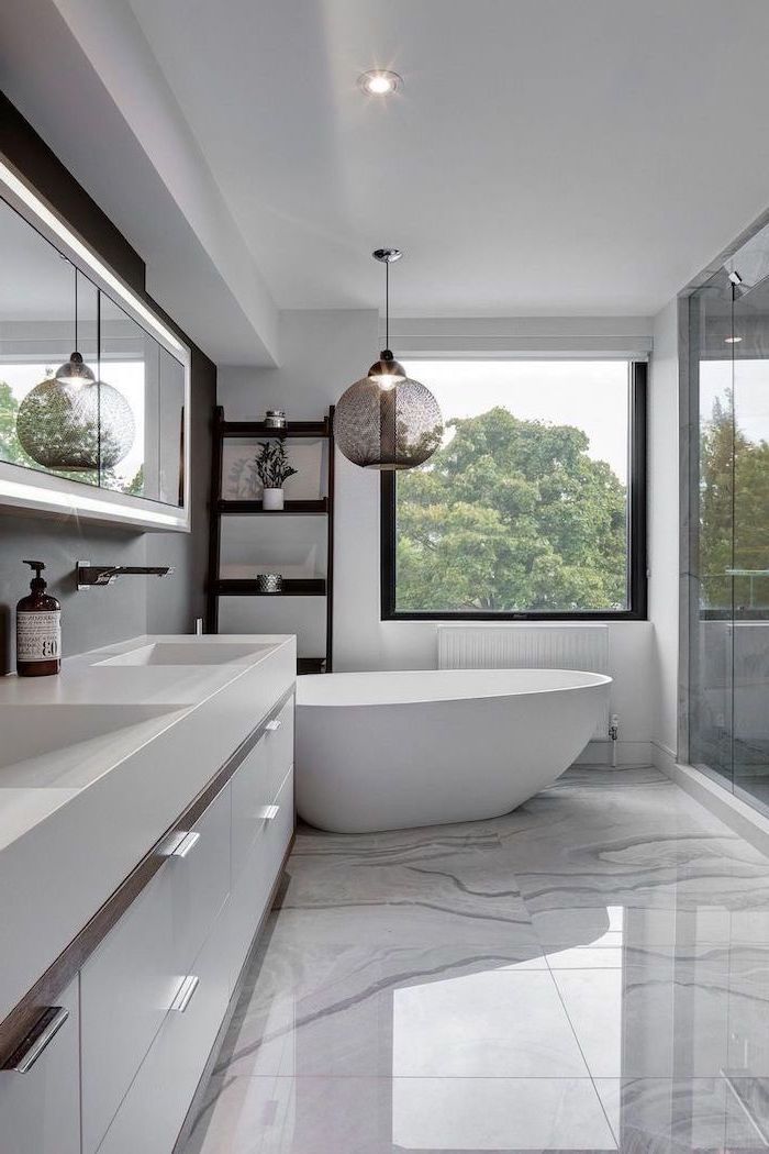 a bathroom with a large bathtub next to a window