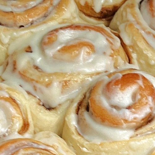 there are many cinnamon rolls with icing on them