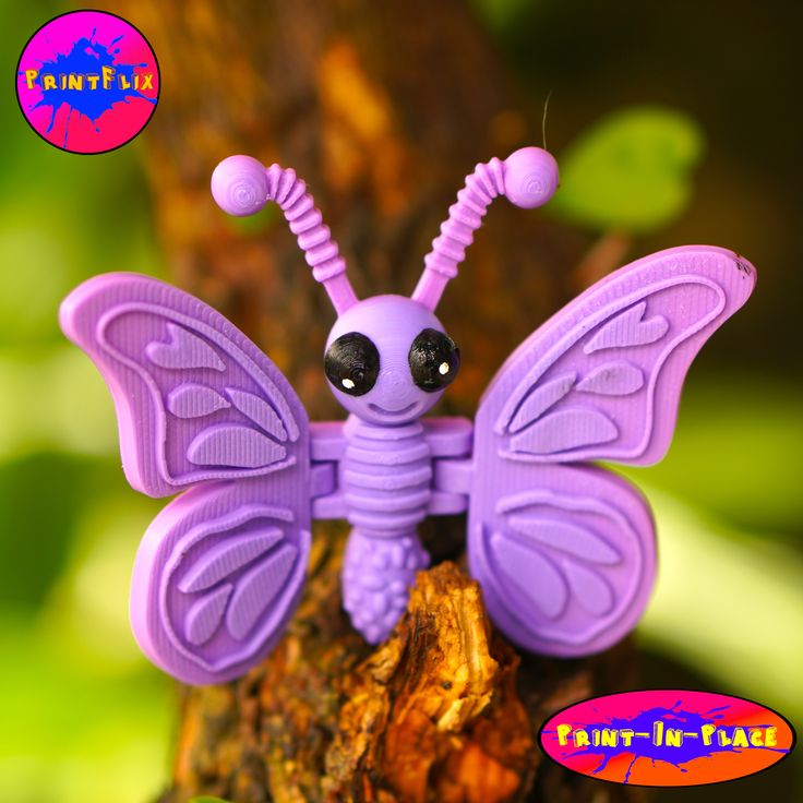 a purple toy sitting on top of a tree branch