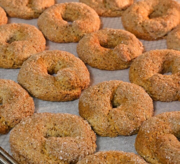 freshly baked donuts on a baking sheet ready to be eaten