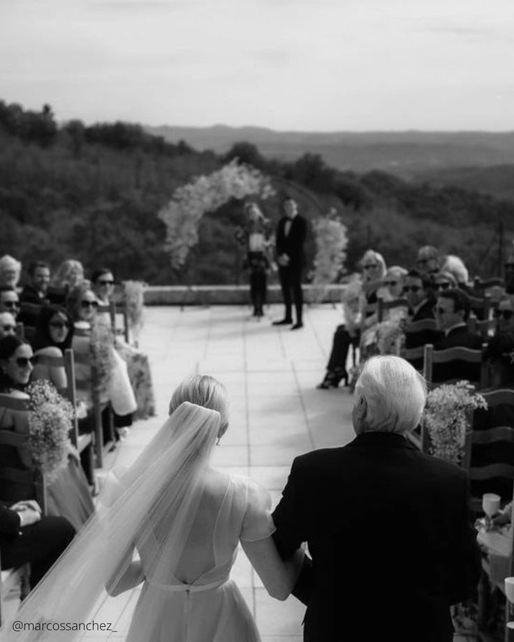 the bride and groom are walking down the aisle