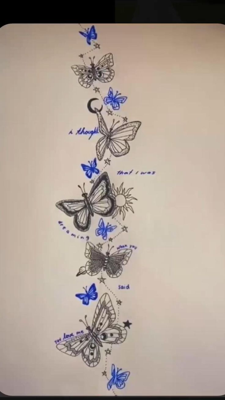 a drawing of butterflies on a white wall with blue writing in the bottom right corner