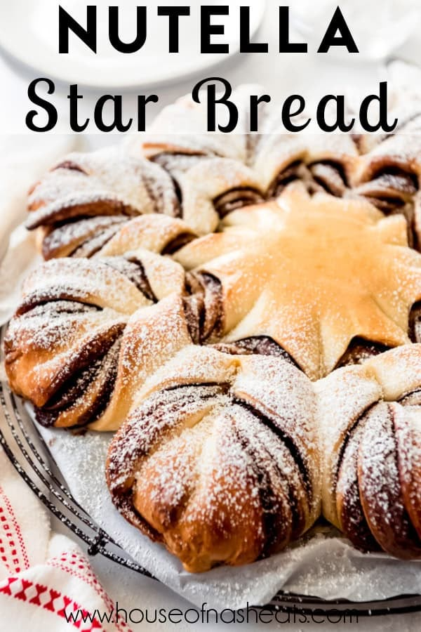 nutella star bread on a plate with powdered sugar sprinkled on top