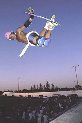 a man flying through the air while riding a snowboard in front of a crowd