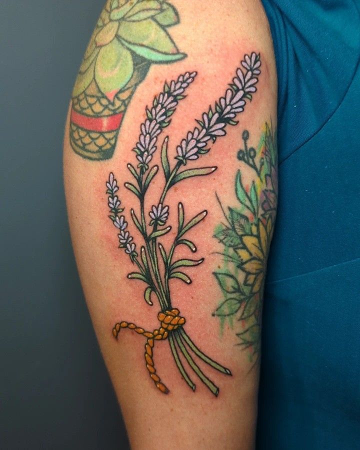 a woman with a tattoo on her arm holding a bouquet of lavenders and an umbrella