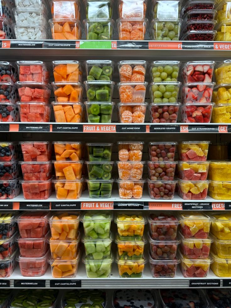 the shelves are filled with many different types of fruits and veggies in plastic containers