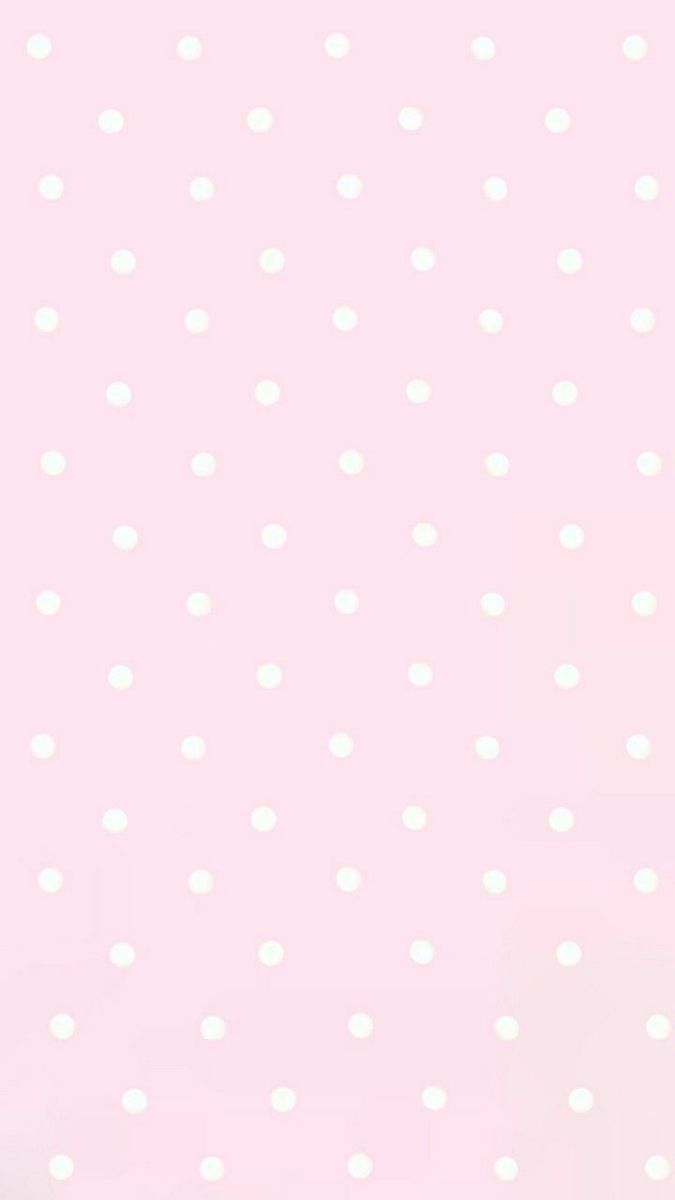 a pink background with white polka dots