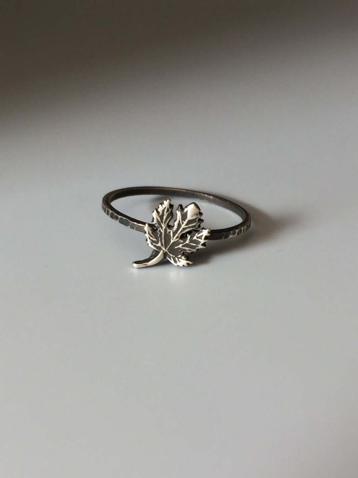 Welcome to Miss November Studio! I specialize in dainty feminine personalized jewelry for the discerning jewelry lover. This listing is for a single sterling silver maple leaf stacking ring. All other rings are sold separately. Make a stack! Add a custom stamped band and two gemstone stacking rings with stones like black onyx and garnet. https://www.etsy.com/listing/150142799/set-of-3-rings-one-personalized-message ********** Stacking rings are excellent accessories, not to mention fun to collect and wear. One ring worn alone is dainty, two is quaint, but a loaded stack is a statement! I love to mix and match my stacking rings. I mix metals and make different stacker themes. Occasionally I wear a single stacking ring with a mantra or a word of encouragement to meditate on. ********** Pleas