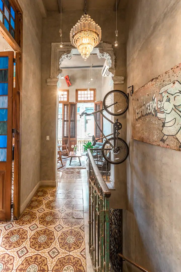 an entry way leading to a dining room and living room with stained glass windows on the walls