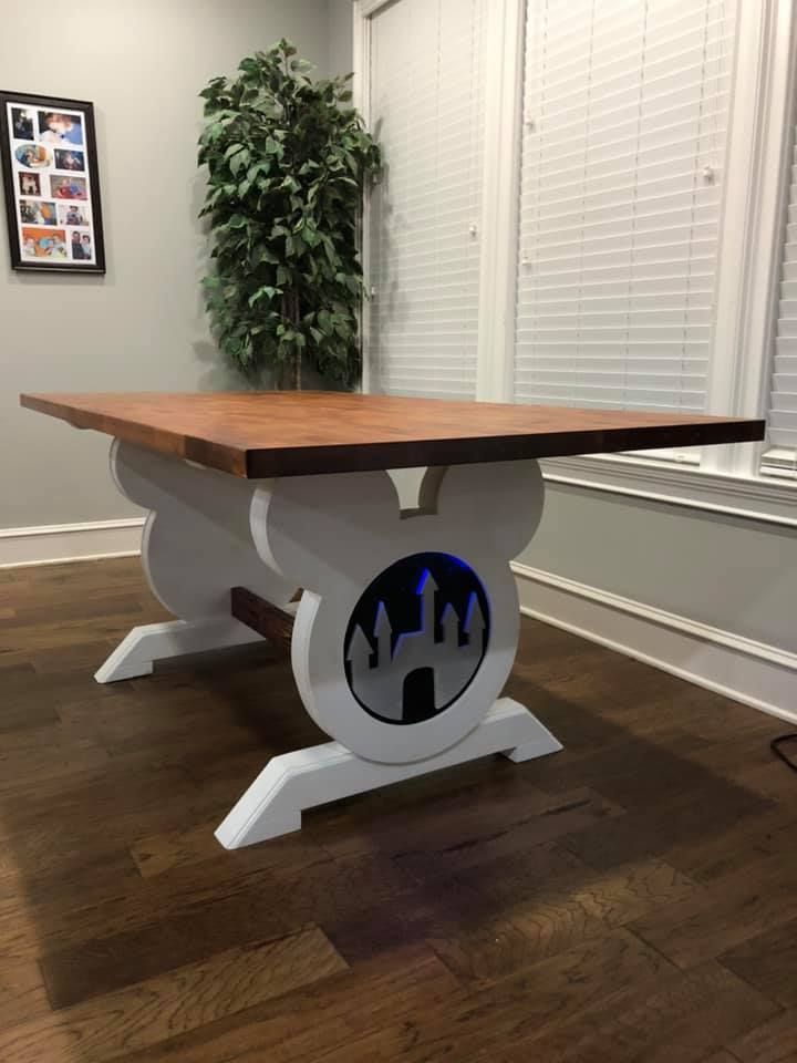 the table is made to look like it has castle silhouettes on it, and sits in front of a window