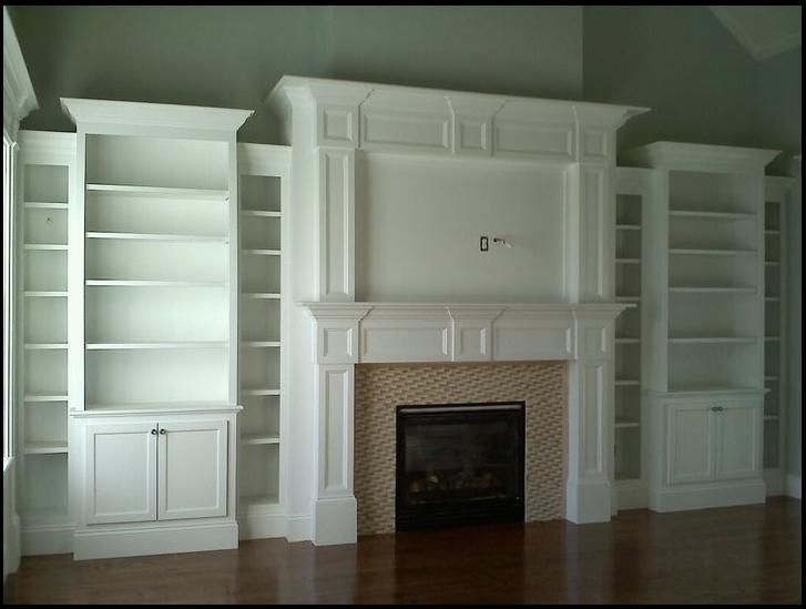 empty living room with fireplace and built in bookcases