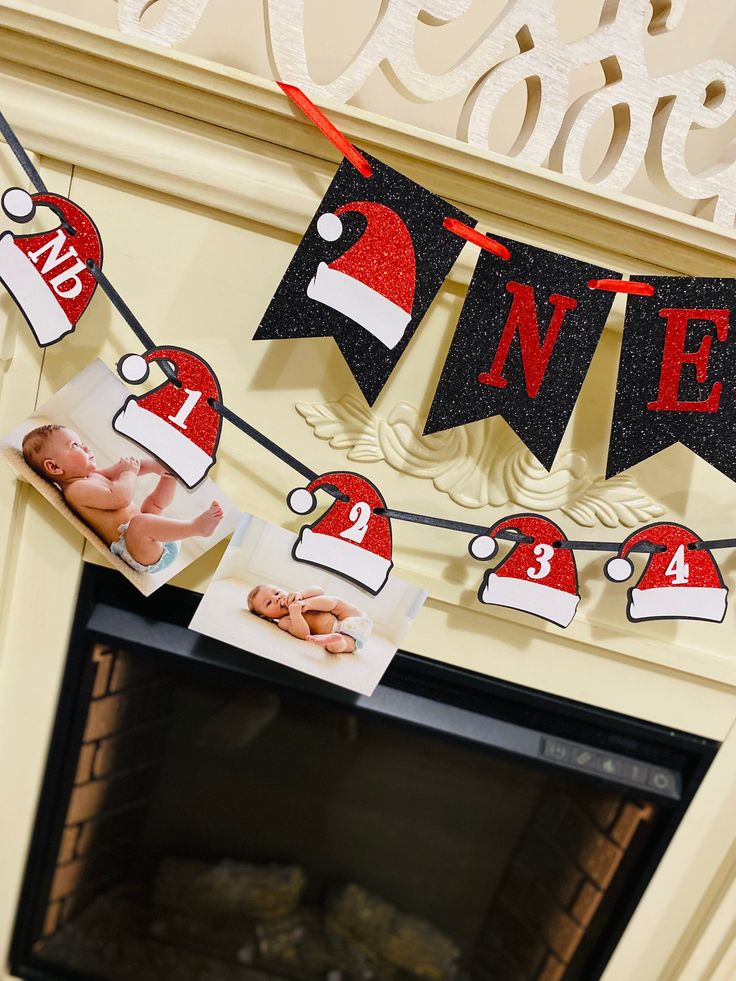 a fireplace decorated for christmas with photos and santa hats hanging from the mantel above it