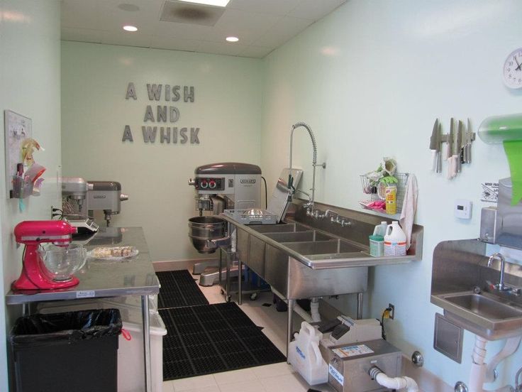 a commercial kitchen with stainless steel appliances and lots of counter space