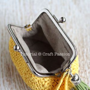 a small purse with a tassel hanging from it