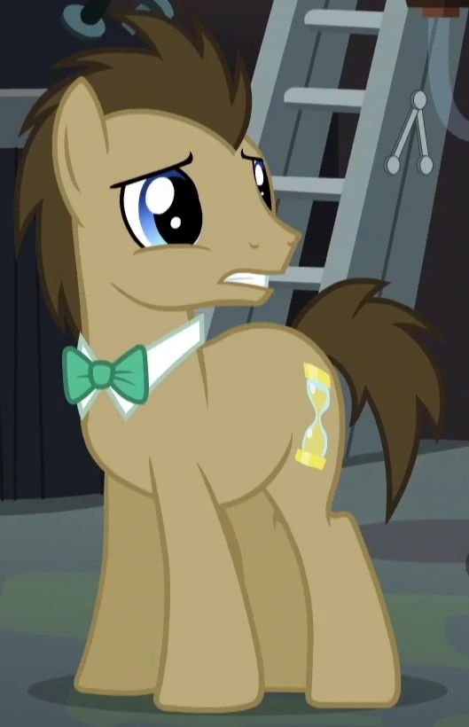 the pony is wearing a bow tie and looking at something in front of him with big eyes