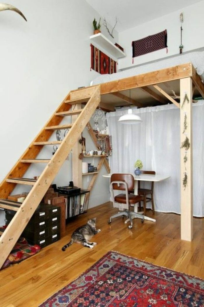 there is a loft bed with stairs to the top and below it, next to a rug on the floor