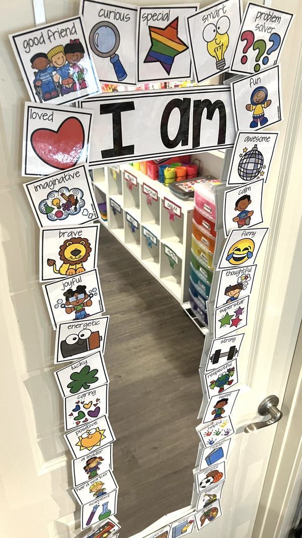 a classroom door decorated with an i am sign and lots of stickers on it