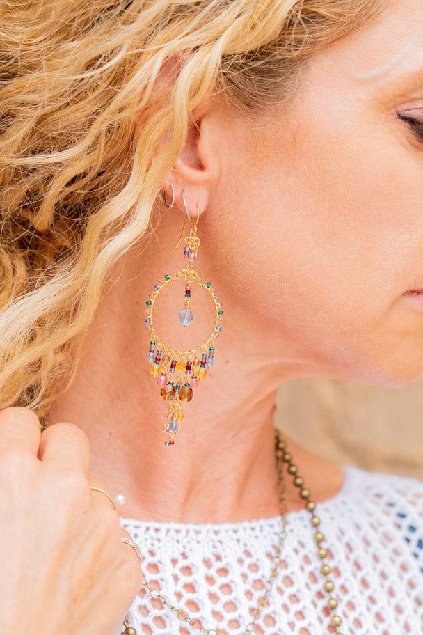 The Hannah Chandelier Earrings in Multi ♡ Product Highlights ♡ Our Hannah Chandelier Earrings in Multi are the perfect accessories to add to any on-trend bohemian style outfit! Layered with any of our many statement necklaces, bracelets, and rings of your choosing, the Hannah Chandelier Earrings in Multi will be sure to be a wonderful addition to any on-trend bohemian style look! ✁ Contents & Measurements ✁ Our Hannah Chandelier Earrings in Multi feature: • An, in diameter, gemstone beaded circl Bohemian Dangle Earrings For Party, Adjustable Bohemian Earrings For Parties, Bohemian Style Crystal Drop Earrings With Dangling Beads, Bohemian Beaded Dangling Earrings, Bohemian Beaded Dangle Earrings, Bohemian Nickel-free Drop Crystal Earrings, Bohemian Nickel Free Crystal Drop Earrings, Bohemian Chandelier Earrings For Pierced Ears, Bohemian Chandelier Earrings With Ear Wire For Festivals