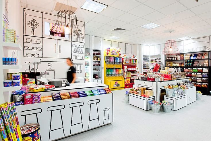 the interior of a grocery store with shelves and counter tops filled with food, drinks and condiments