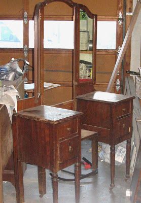 three wooden tables and two mirrors in a room