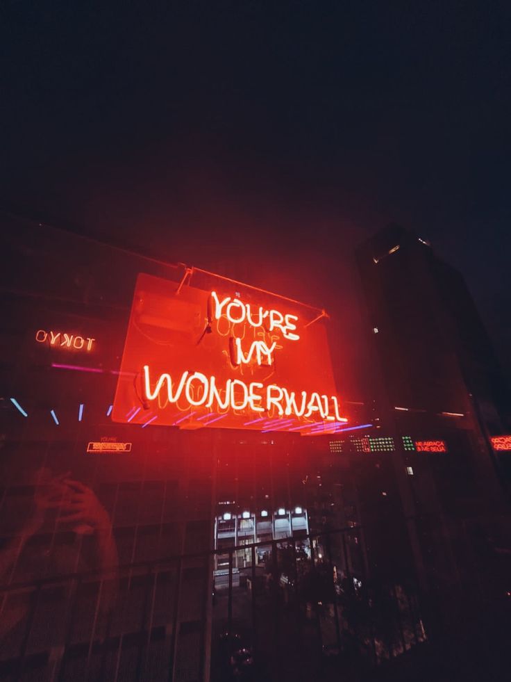 a neon sign that says you're my wonderwall on the side of a building