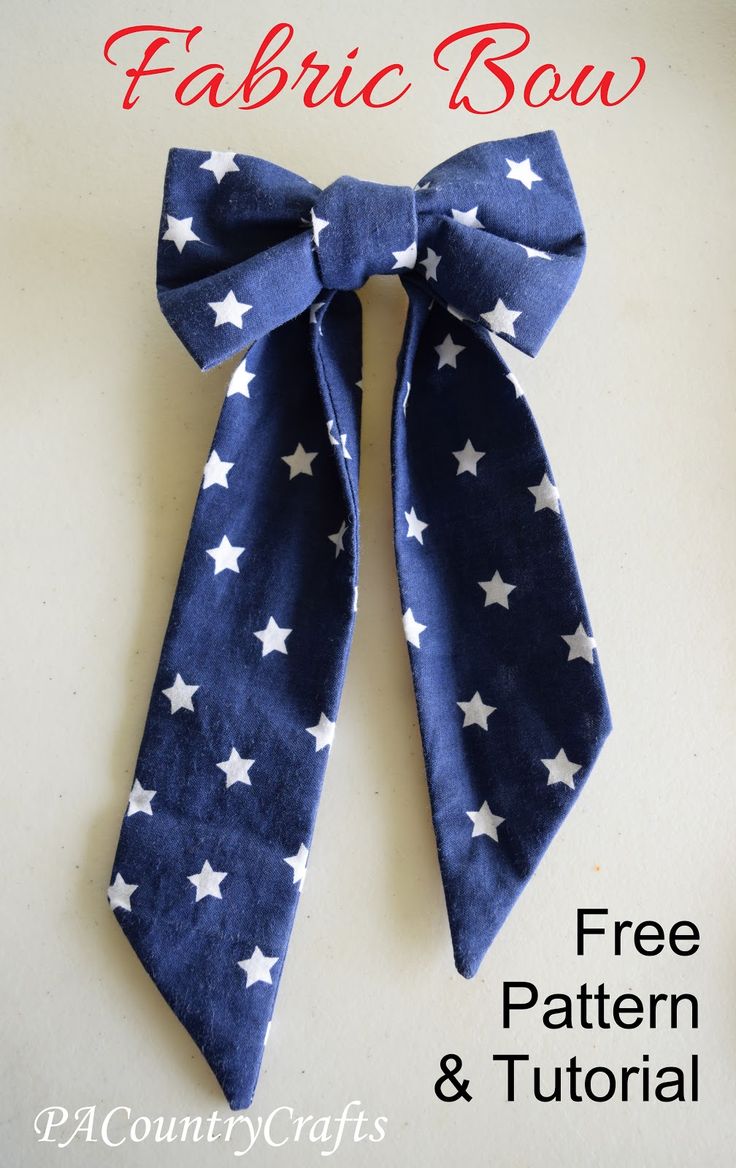 a blue bow with white stars on it and the words fabric bow written in red