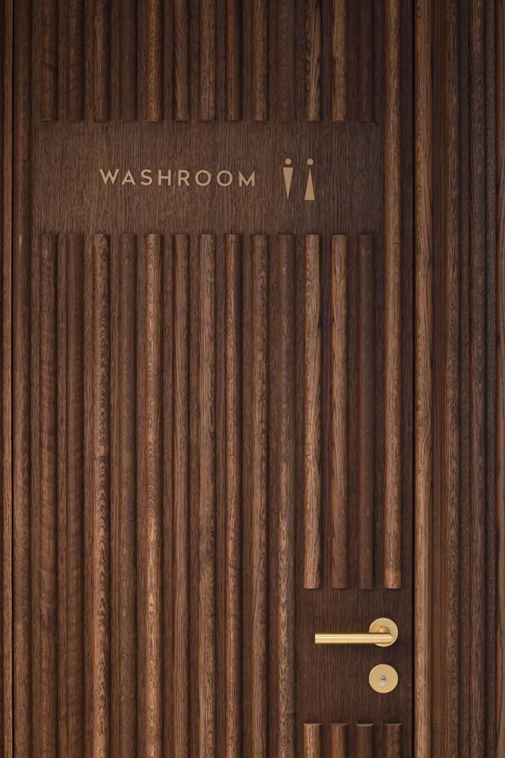 a wooden door with the word washroom on it's front and side panels