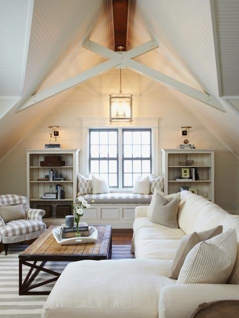 a living room filled with furniture and a large window