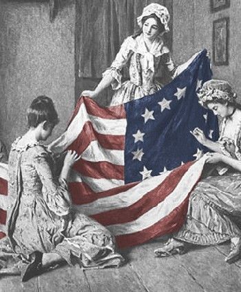 an american flag being hung up by three women in the room with other people around it