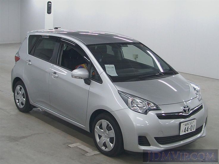 a small silver car parked in a garage