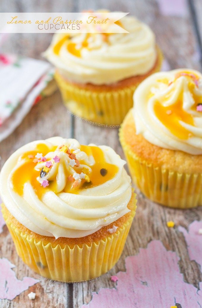 three yellow cupcakes with white frosting and sprinkles on top