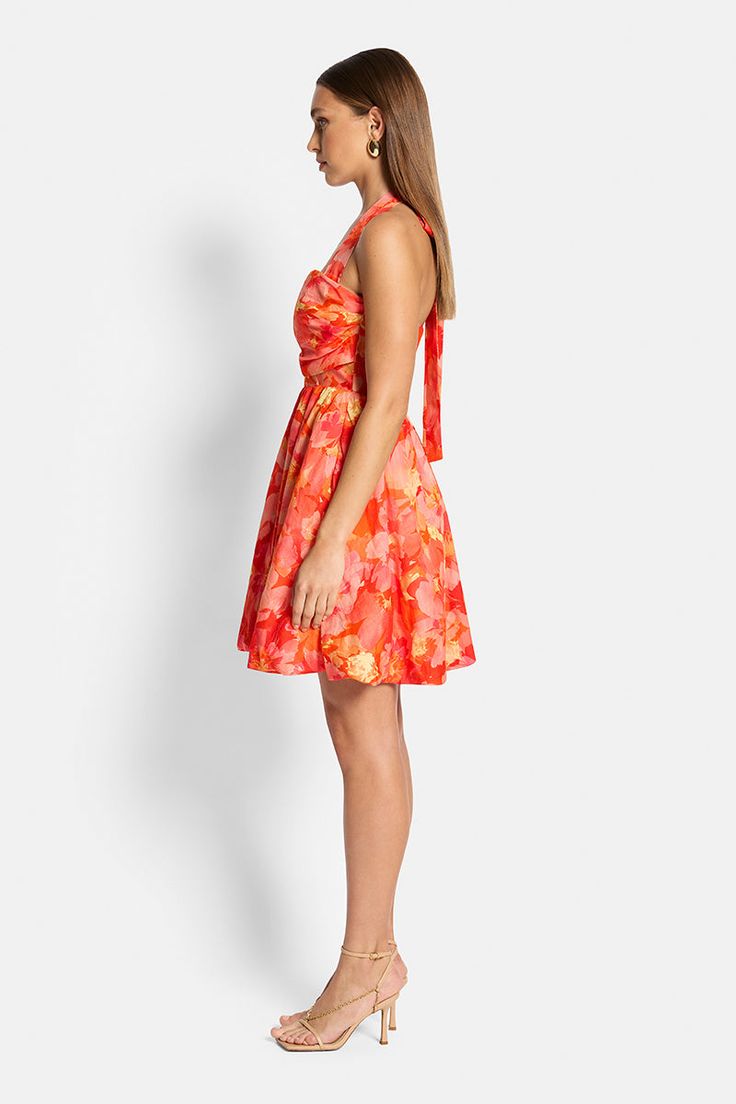 Elevate your style with the Amara Bubble Mini Dress in our captivating Red & Pink Floral print. Its structured bodice accentuates your curves flawlessly, while the subtle bubble hemline adds a touch of playfulness. The removable halter strap offers versatile elegance, allowing you to flaunt it as a chic halter or a stunning strapless piece. Make a statement in this enchanting ensemble. Model is 175cm tall and wears a size 8.Fits true to size. - 100% Ramie- 100% Cotton Lining- Fitted bodice- Bubb Red Ruched Mini Dress With Fitted Bodice, Elegant Red Floral Print Mini Dress, Red A-line Ruched Dress, Elegant Red Mini Dress With Floral Print, Red Ruched A-line Dress, Red Silk Dresses With Sweetheart Neckline, Red Silk Dress With Ruched Bodice, Red Mini Dress With Ruched Fitted Bodice, Red Mini Dress With Fitted Bodice For Spring