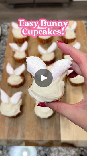 someone is holding up a cupcake with bunny ears on it