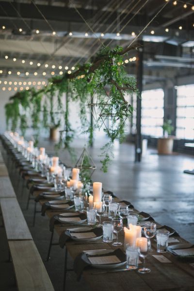 a long table is set with candles and place settings