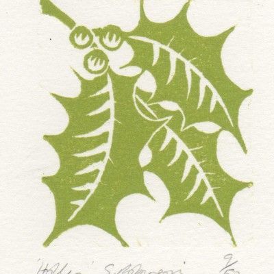 a green and white christmas card with holly leaves