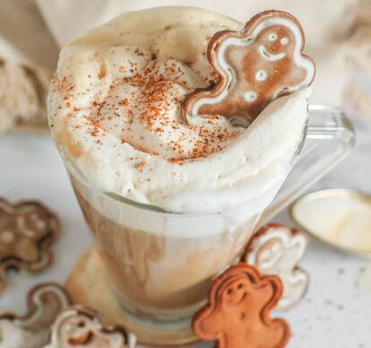 a cup filled with whipped cream and topped with ginger cookies