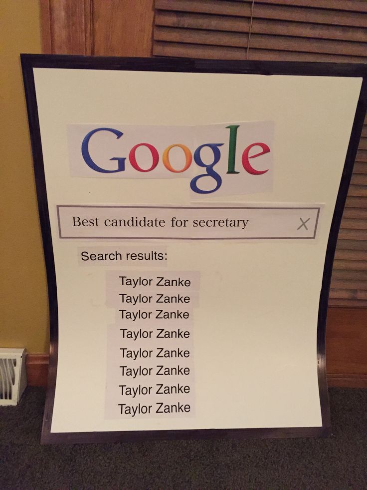 a sign that is sitting on the floor in front of a window with google written on it