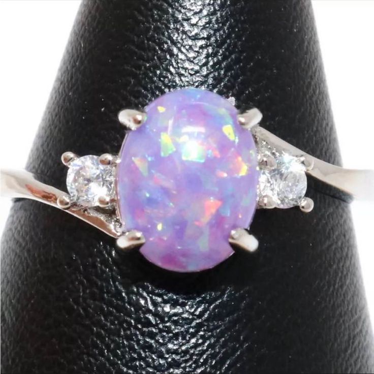 1 Ct Oval Center Stone Of Purple Fire Opal!! It Also Has Two Small Clear Cubic Zirconia Stones, One On Each Side Of The Center Stone!! The Ring Is White Gold Plated!! Size And Is 7 Women’snew & Unused.. Please Refer To The Pics!! Lavender Opal Ring, Elegant Silver Opal Ring With Accent Stones, Elegant Silver Opal Ring With Cubic Zirconia, Silver Opal Ring With Cubic Zirconia Center Stone, Silver Opal Ring With Diamond Accents, Elegant Silver Opal Ring With Diamond Accents, Classic Silver Opal Ring With Accent Stones, Silver Opal Ring With Accent Stones, Round Cut, Silver Diamond Opal Ring With Prong Setting