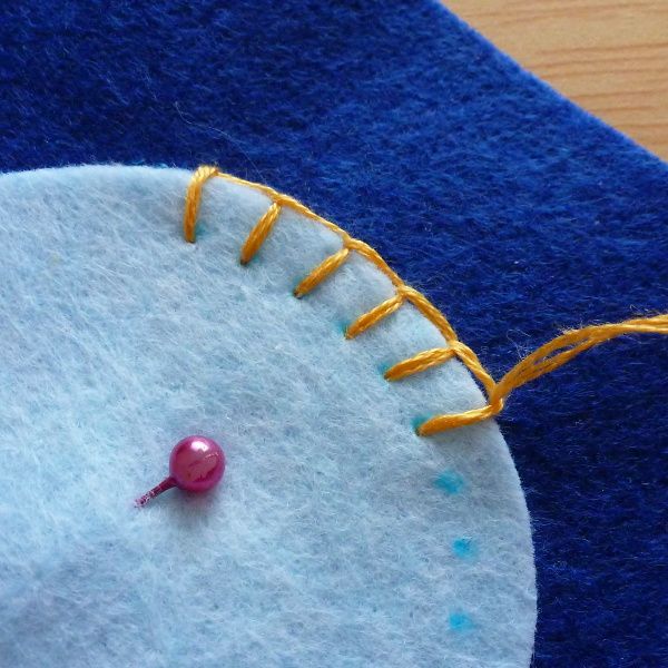 a close up of a piece of felt with pins