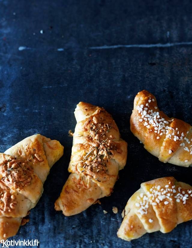 four croissants with powdered sugar and seasoning sprinkled on them