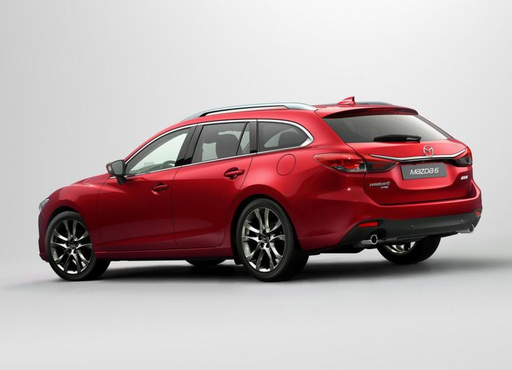 the rear end of a red mazda hatchback parked in front of a white background