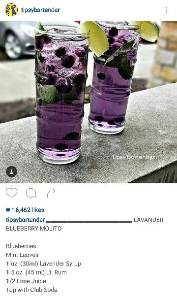 two glasses filled with purple liquid sitting on top of a table