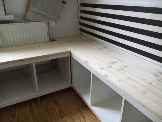 an empty room with white shelves and black stripes on the wall, along with a radiator