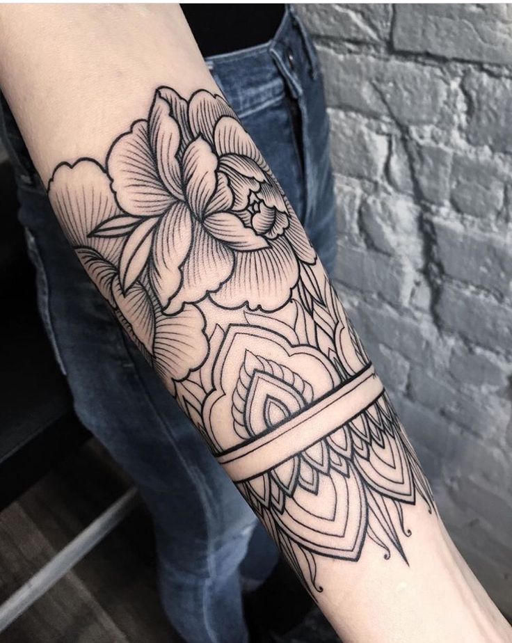 a person with a flower tattoo on their arm