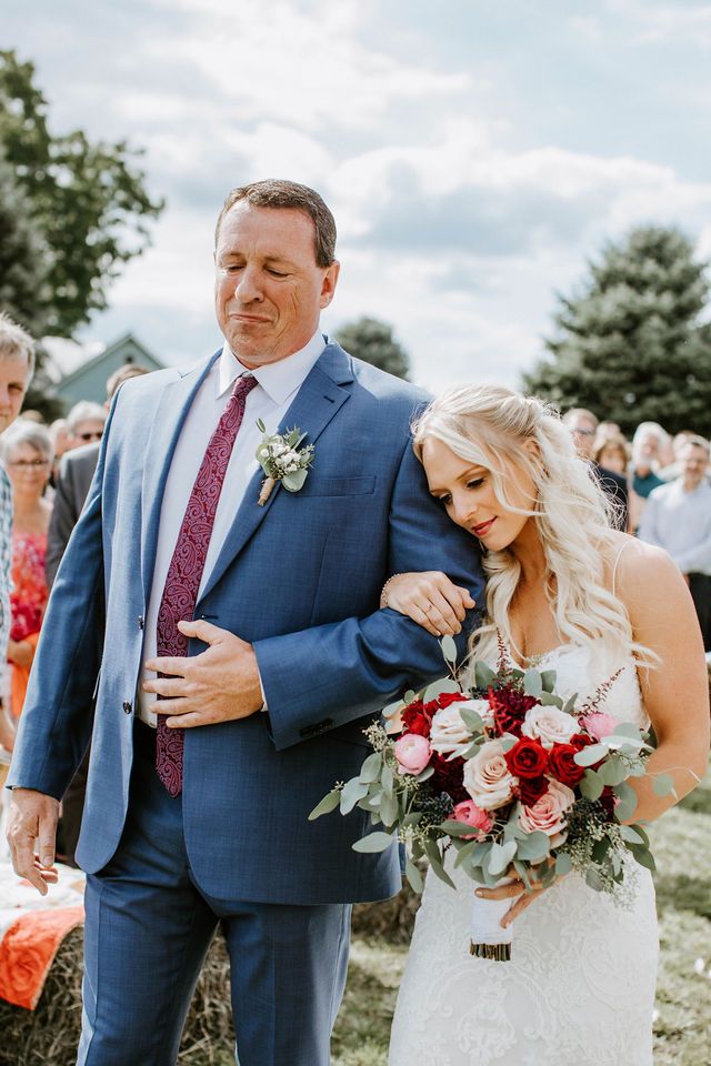 a bride and her father walking down the aisle