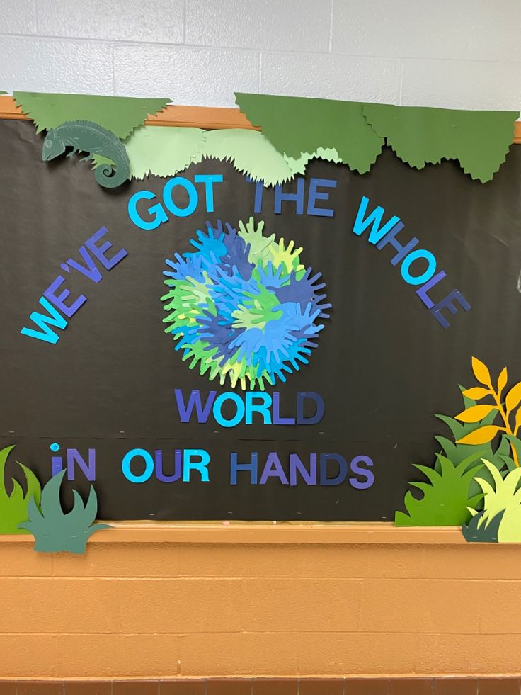 a bulletin board with the words we've got the whole world in our hands